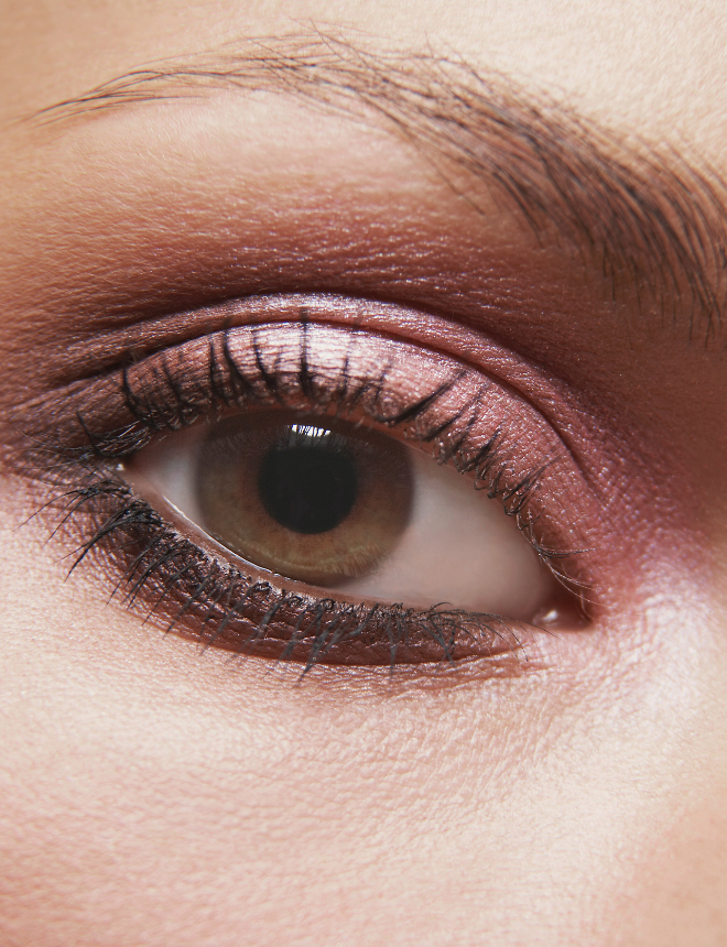 Nahaufnahme eines Auges mit rosa-braunem Lidschatten und schwarzer Wimperntusche