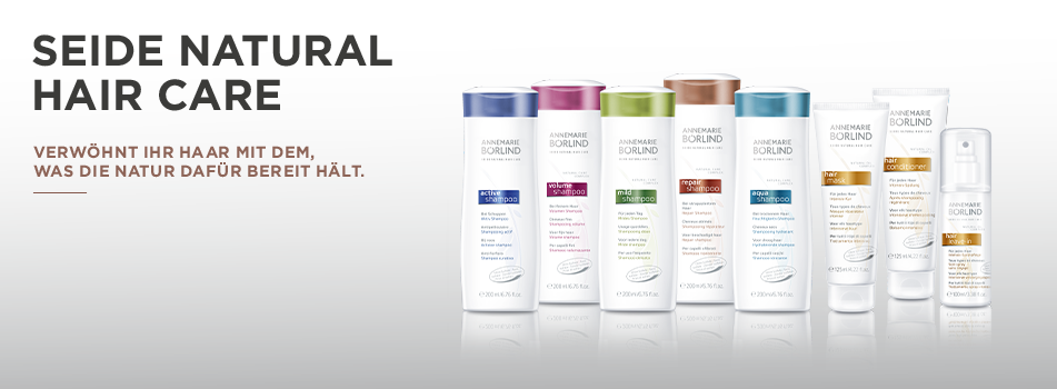 Pflegeserie für Haare mit weißen Flaschen, stilisiertem Seidenglanz – Text: ‚Seide Natural Hair Care.