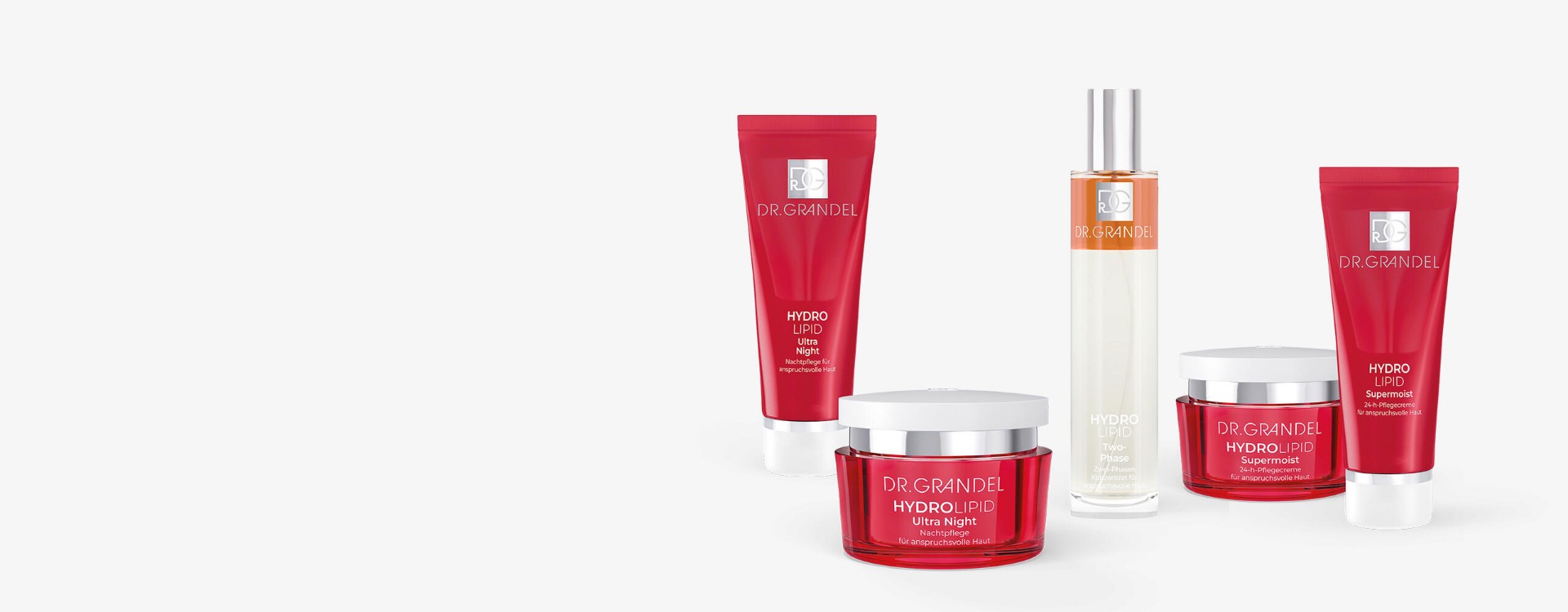 Dr. Grandel Hydro Lipid Pflegeserie mit roten Tuben und Tiegeln sowie einem durchsichtigen Flakon mit orangefarbener Flüssigkeit vor hellem Hintergrund.